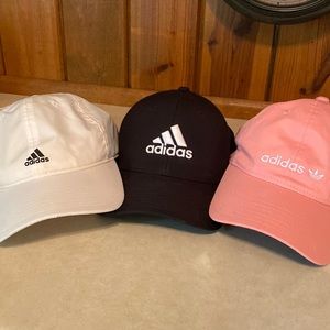 Three ladies adidas hats pink, white and black
